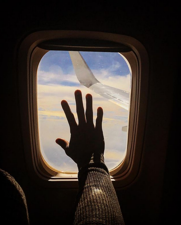 Hand on window's airplane